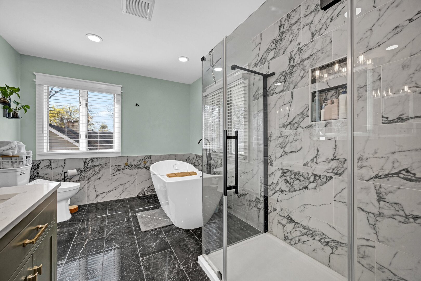 903 Crestline Drive Normal, IL 61761 - Photo 22 of 35 a bathroom with a sink toilet a mirror and shower