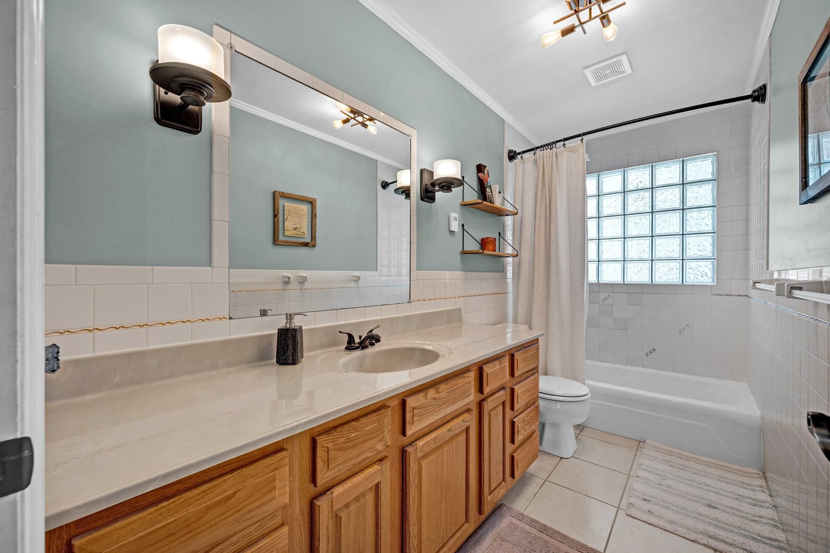 903 Crestline Drive Normal, IL 61761 - Photo 27 of 35 a bathroom with a double vanity sink a mirror and a bathtub