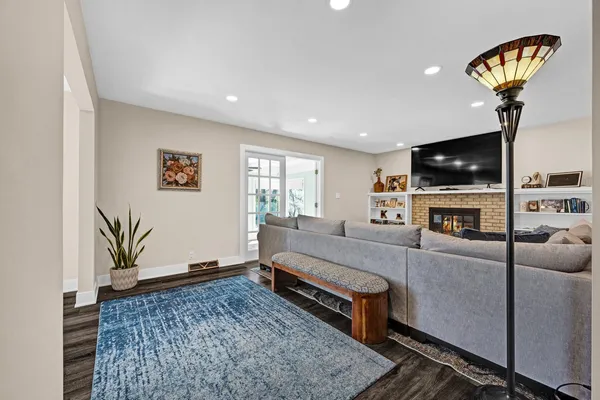 a living room with furniture a flat screen tv and a fireplace