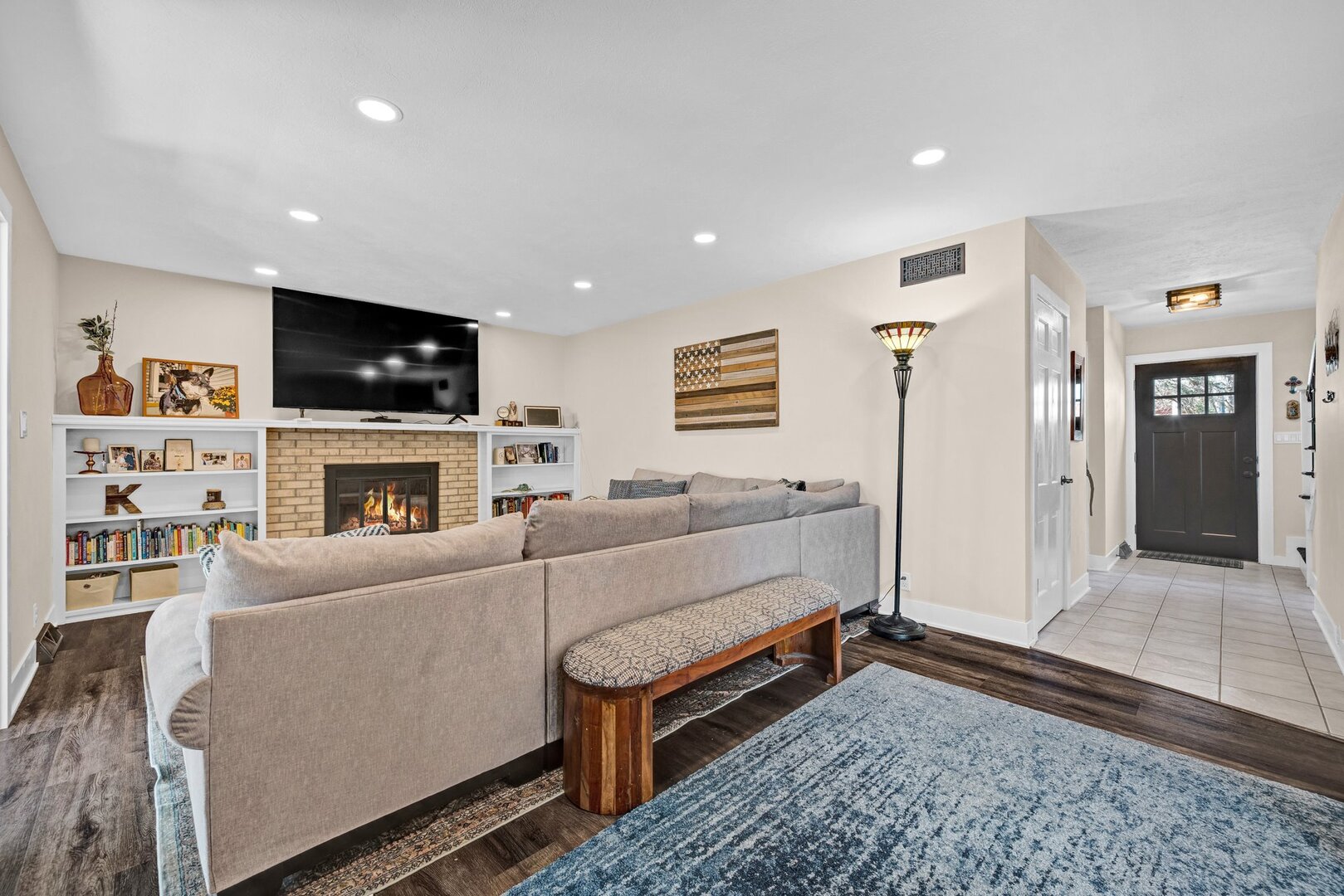 903 Crestline Drive Normal, IL 61761 - Photo 6 of 35 a living room with furniture a flat screen tv and a fireplace