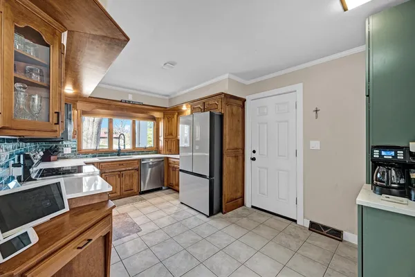 a kitchen with a stove sink and cabinets