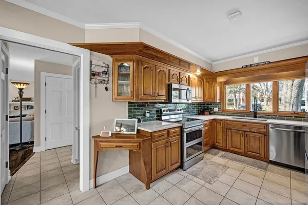a kitchen with stainless steel appliances granite countertop a refrigerator and a sink