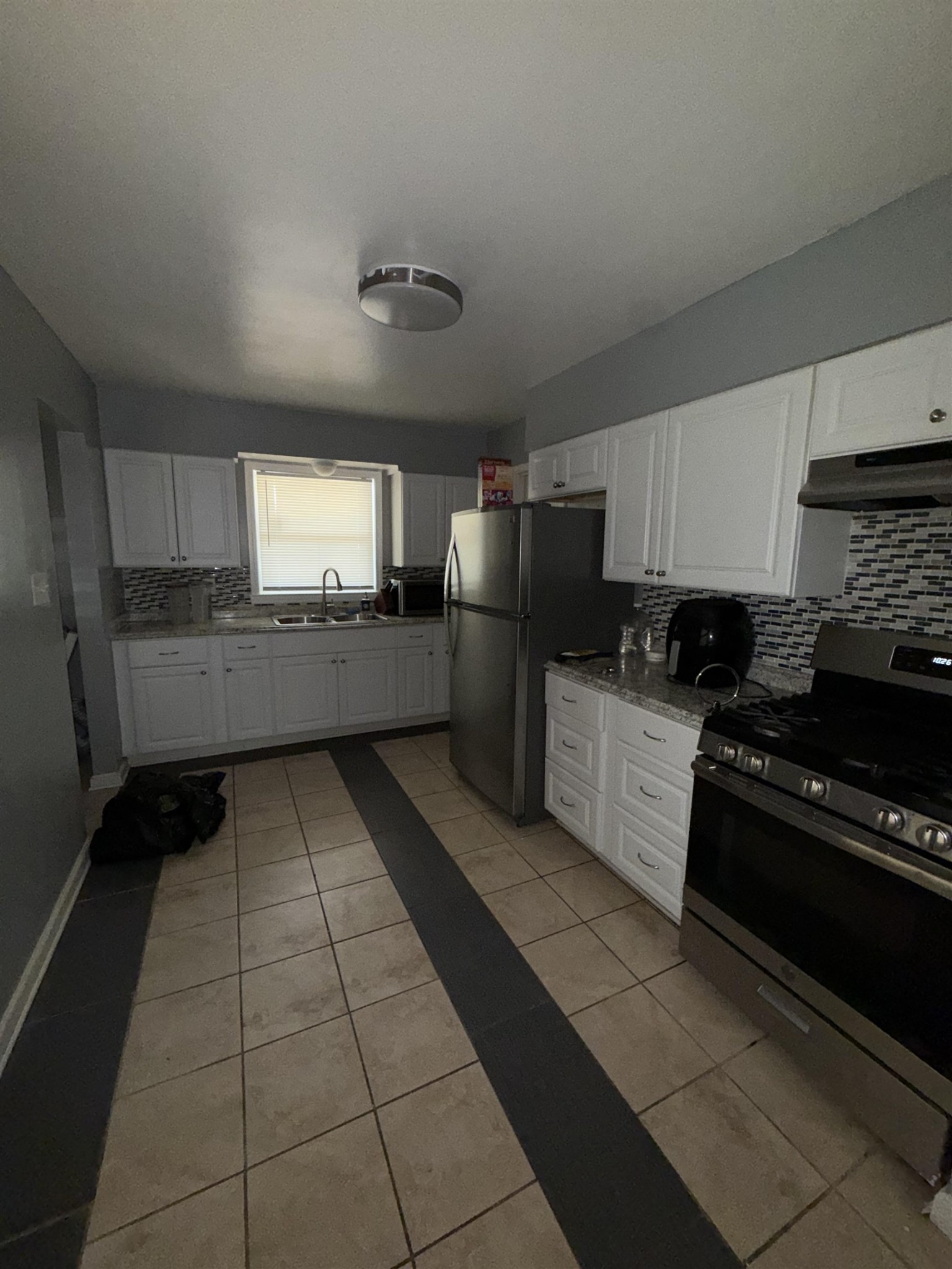 179 Ivan Road Memphis, TN 38109 - Photo 12 of 22 a large kitchen with a stove a sink dishwasher and a refrigerator