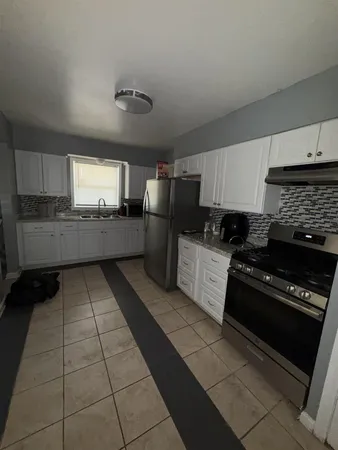 a kitchen with a cabinets and steel appliances