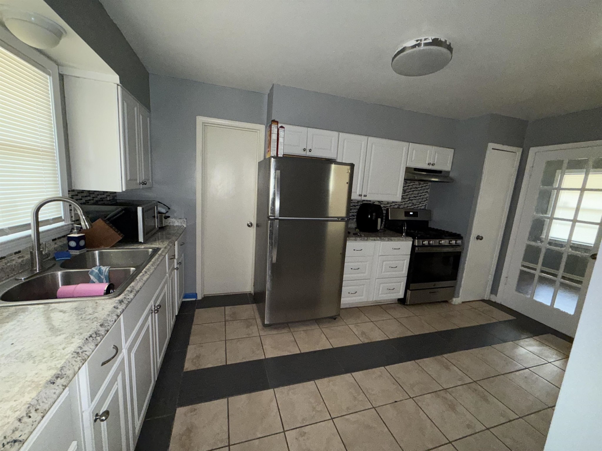 179 Ivan Road Memphis, TN 38109 - Photo 15 of 22 a kitchen with granite countertop a refrigerator and a sink