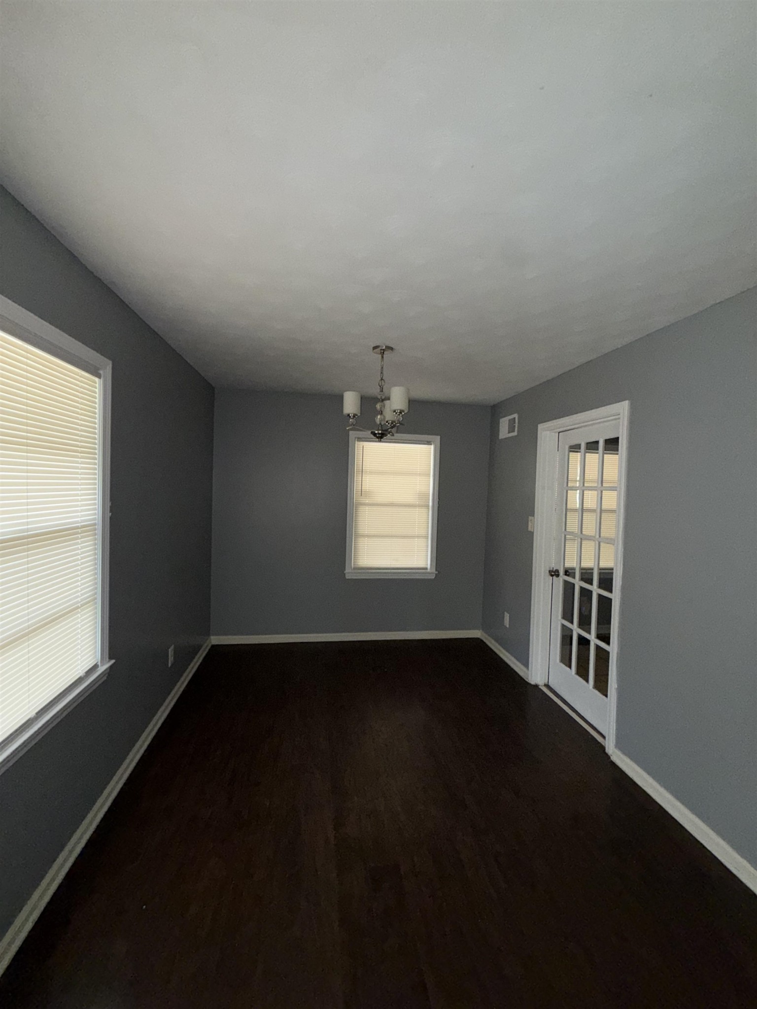 179 Ivan Road Memphis, TN 38109 - Photo 6 of 22 a view of an empty room with wooden floor and a window