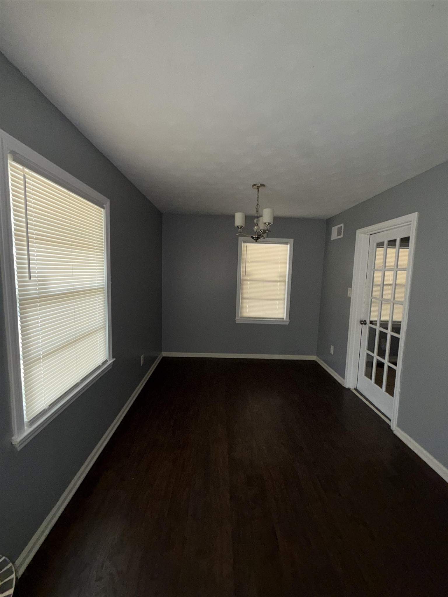 179 Ivan Road Memphis, TN 38109 - Photo 7 of 22 a view of an empty room with wooden floor and a window