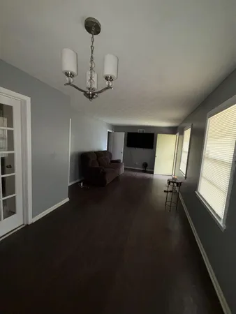 a view of empty room with a ceiling fan and window