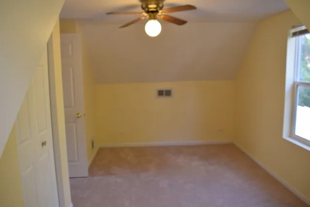 a view of a room with a window and closet area