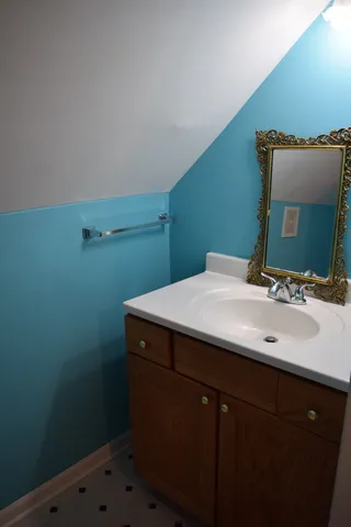 a bathroom with a sink and a mirror