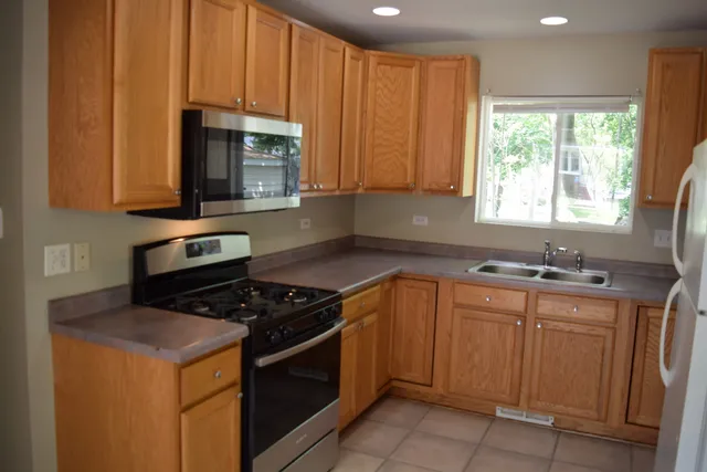 a kitchen with a stove a sink and a microwave