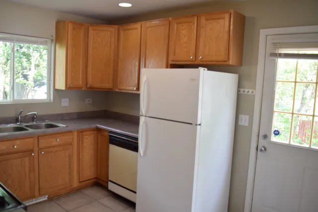 a white refrigerator freezer sitting in a kitchen