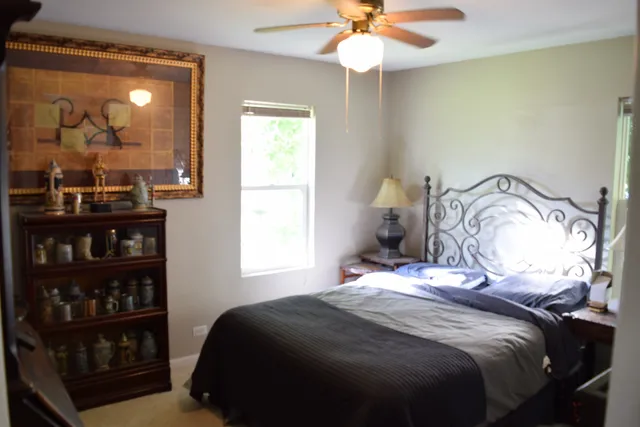 a bedroom with a bed and window