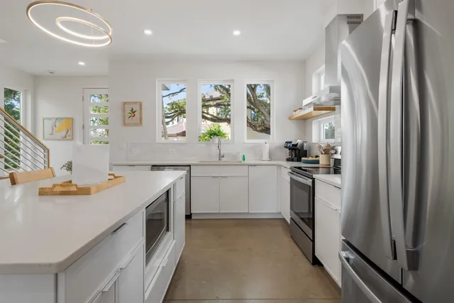 a kitchen with white cabinets and stainless steel appliances