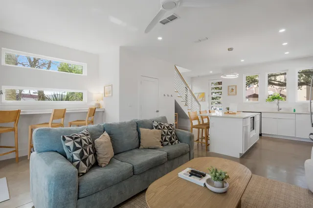 a living room with furniture and kitchen view