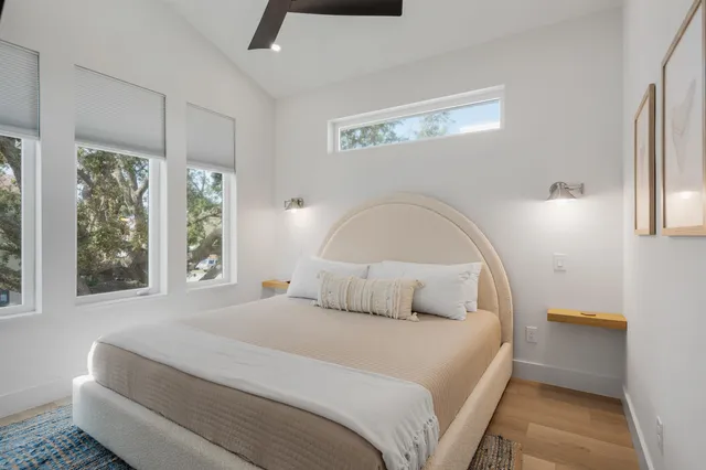 a bedroom with a bed and wooden floor