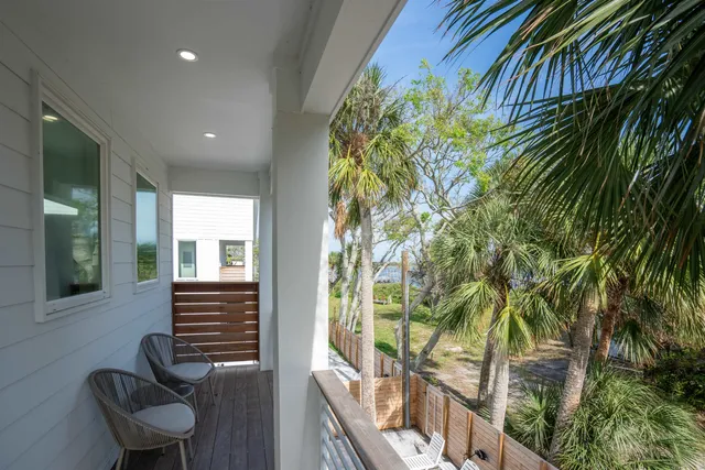 a view of balcony with a potted plant and outdoor seating