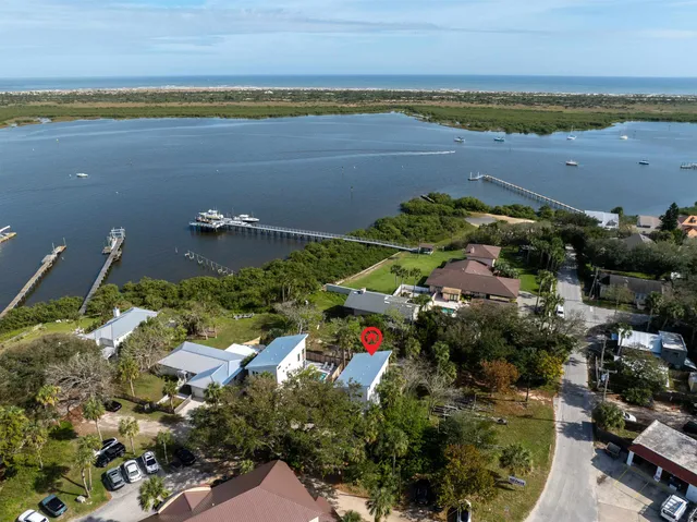 an aerial view of ocean and houses with outdoor space