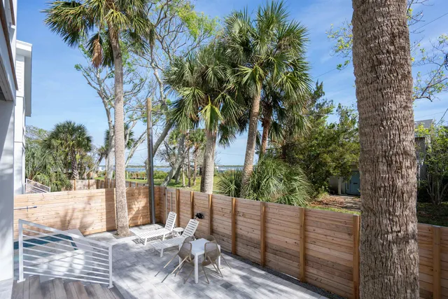 a view of a yard with wooden fence
