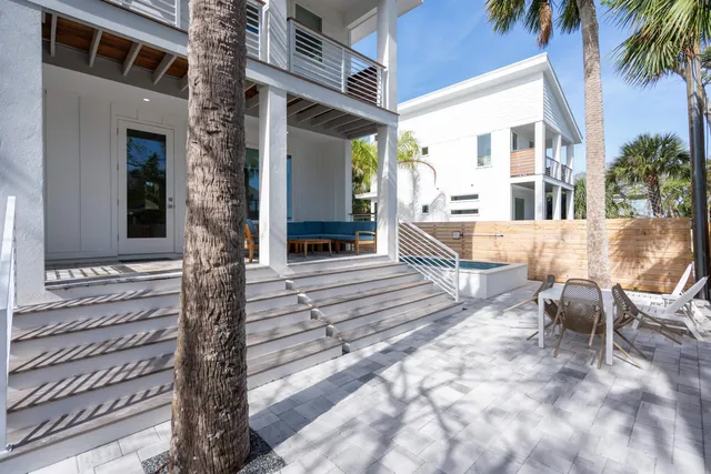 a view of a house with backyard and sitting area