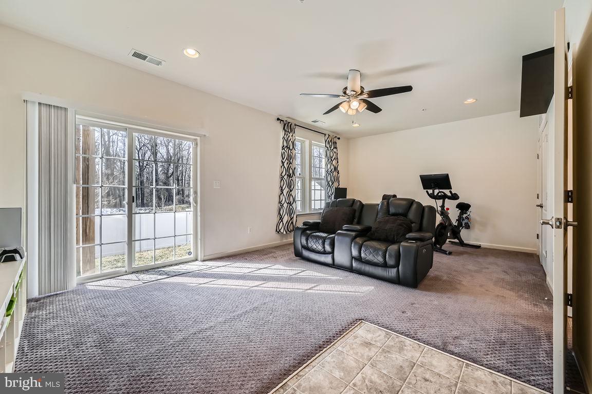 916 Morgan Run Road Baltimore, MD 21220 - Photo 6 of 37 a living room with furniture a ceiling fan and a window