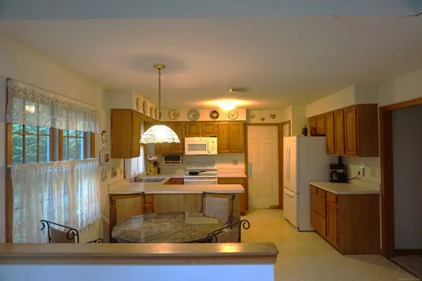 a living room with stainless steel appliances kitchen island granite countertop furniture and a view of living room