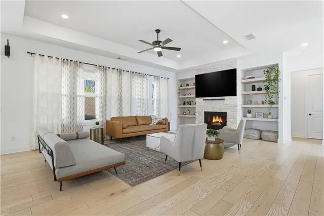 a kitchen with stainless steel appliances granite countertop a sink a stove a refrigerator and island with wooden floor