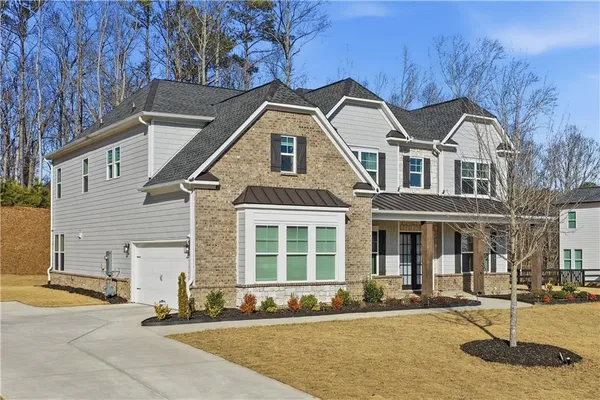 a front view of a house with a yard
