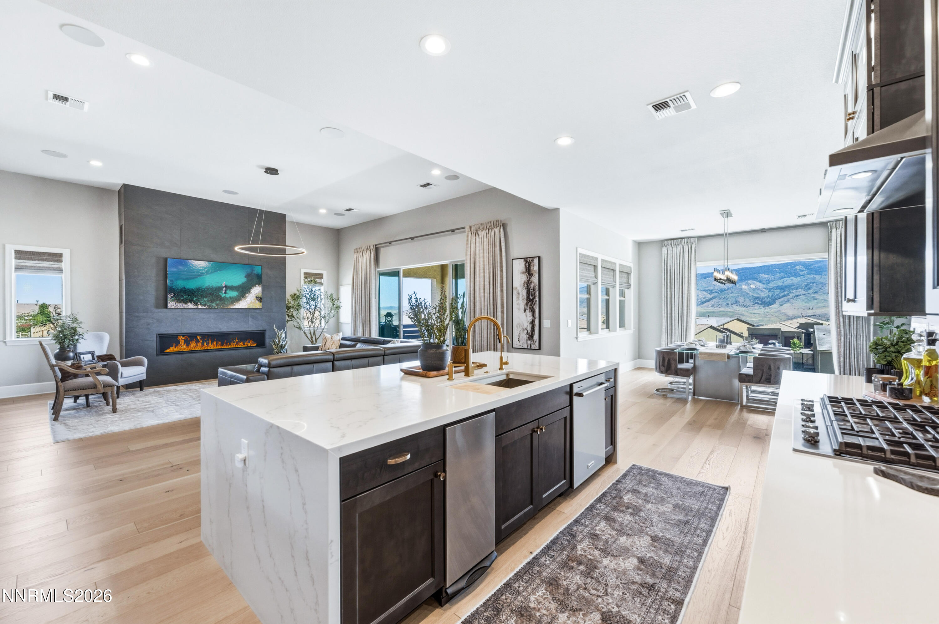 9028 Iron Sky Court Reno, NV 89523 - Photo 8 of 36 a large kitchen with stainless steel appliances a lot of counter space and a living room