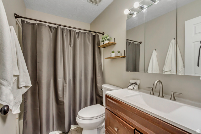 933 South Freedom Boulevard, Unit 7 Provo, UT 84601 - Photo 15 of 23 Full bath with vanity, a shower with curtain, and a textured ceiling