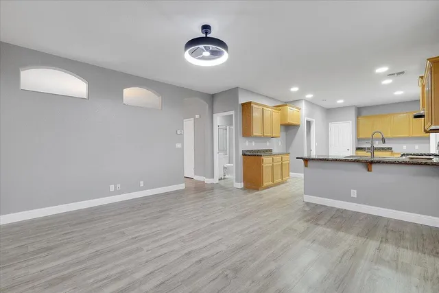 a view of kitchen with stainless steel appliances granite countertop a refrigerator and a sink
