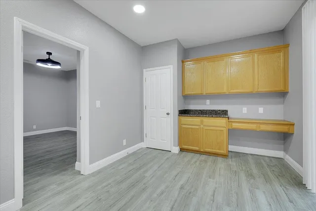 a view of a kitchen with wooden floor and a sink