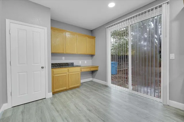 a view of a kitchen with wooden floor and a sink