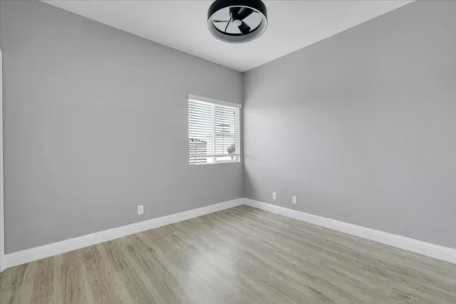 an empty room with a empty space and windows