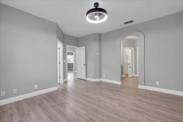 a view of a room with wooden floor and window