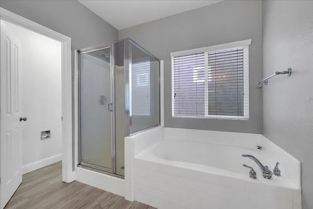 a bathroom with a bathtub and shower