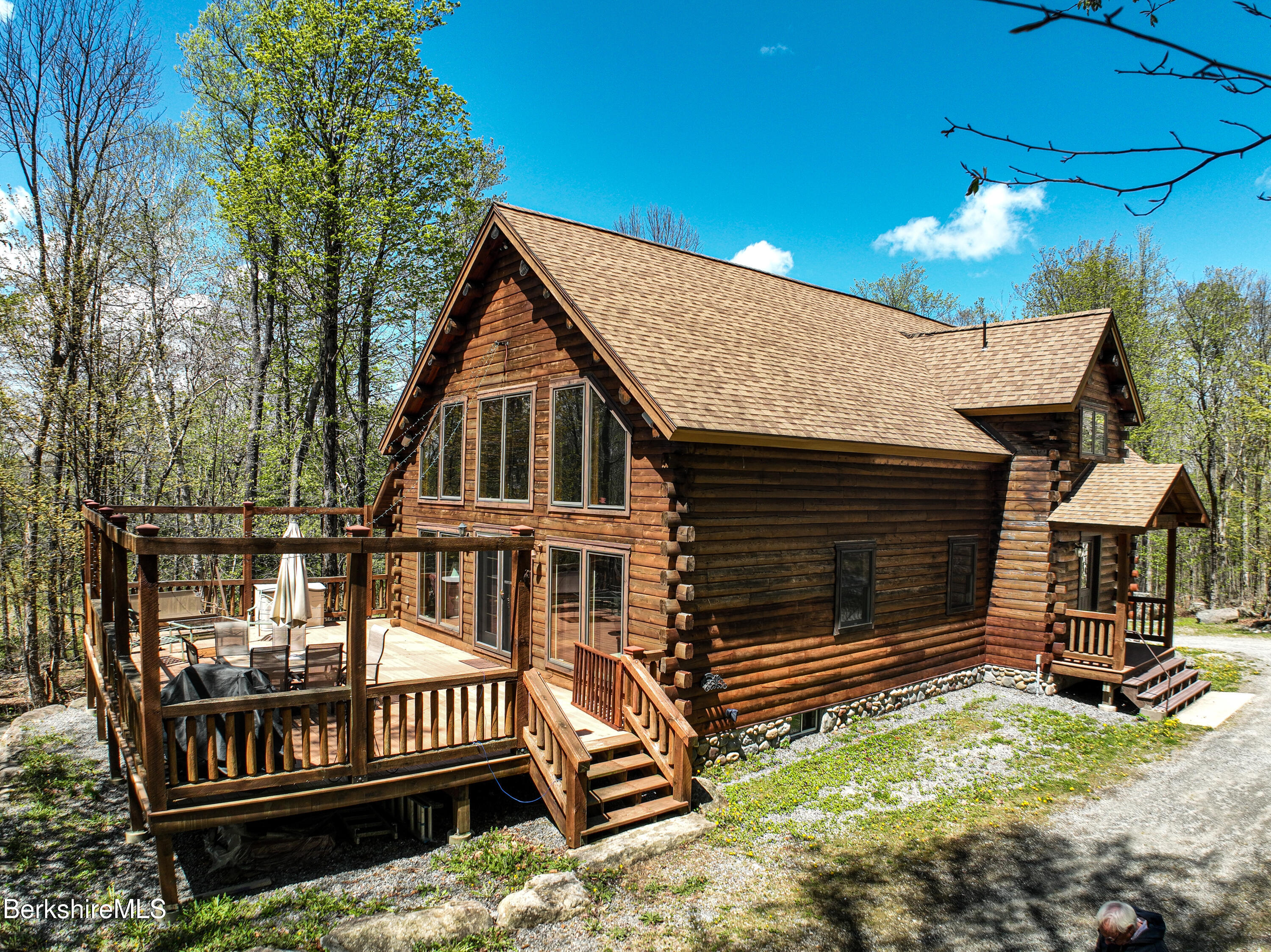 233 Algerie Road Becket, MA 01223 - Photo 2 of 48 a view of a house with a wooden deck and a yard