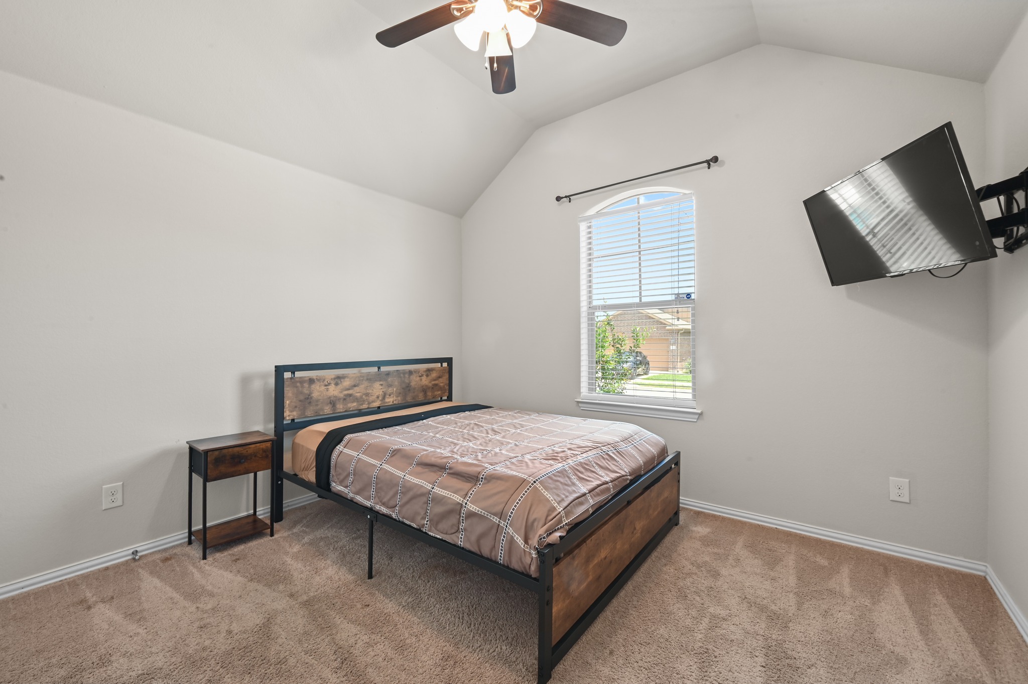 877 Hot Spring Valley Buda, TX 78610 - Photo 21 of 36 a bedroom with a bed and a chandelier