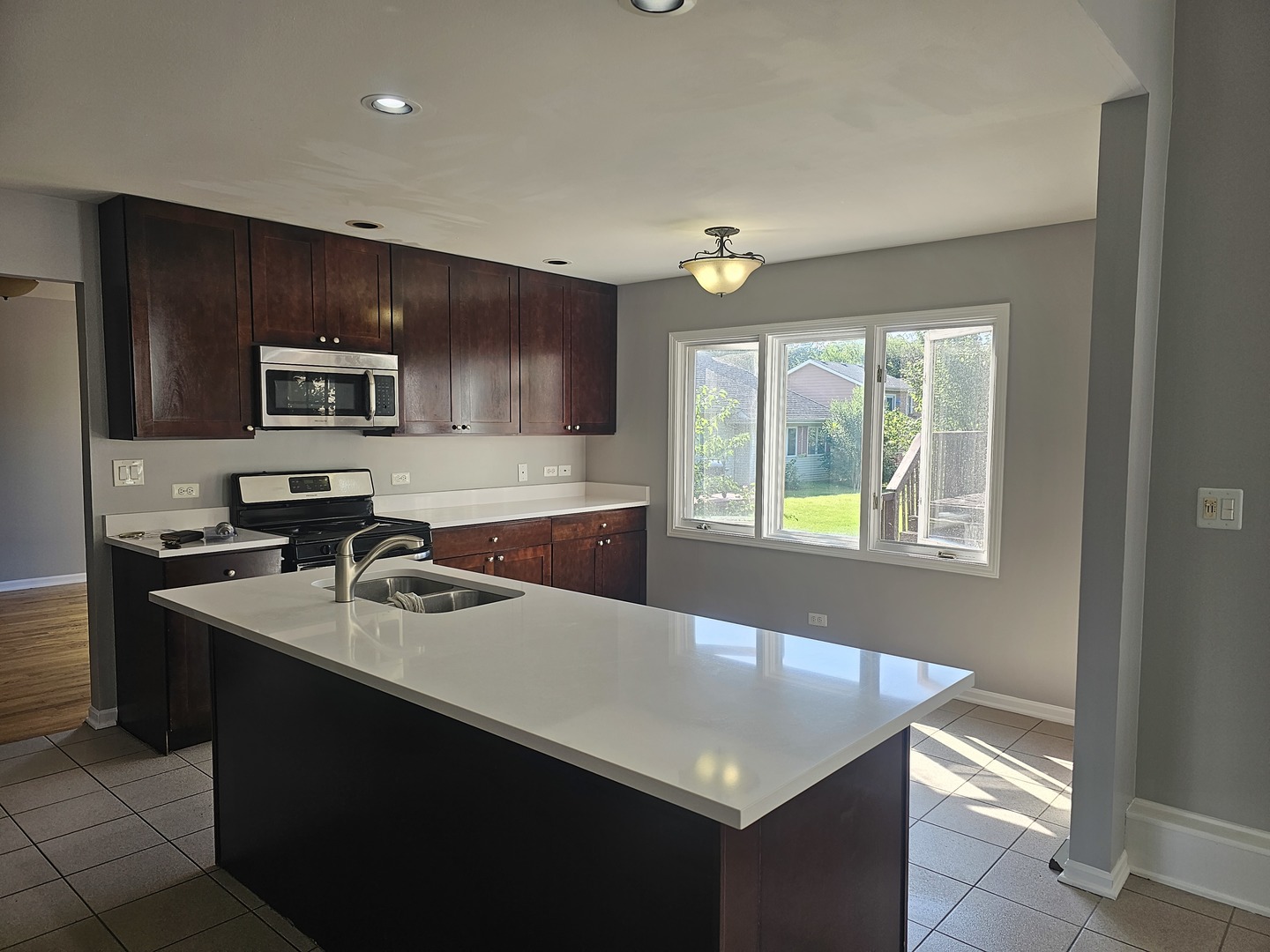1821 Terrace Road Homewood, IL 60430 - Photo 4 of 9 a kitchen with a sink stove and microwave