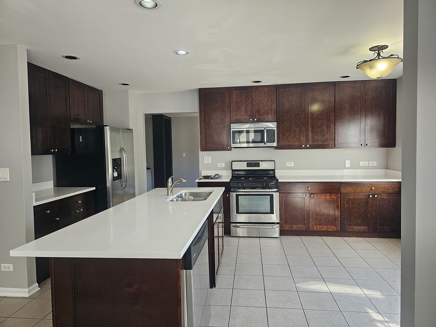 1821 Terrace Road Homewood, IL 60430 - Photo 5 of 9 a kitchen with kitchen island granite countertop a stove a sink and a refrigerator