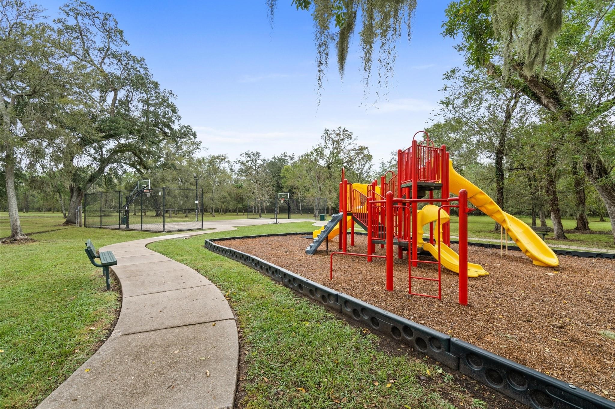814 Cross Timbers Drive Rosharon, TX 77583 - Photo 4 of 5 a park view with a bench and trees in the background