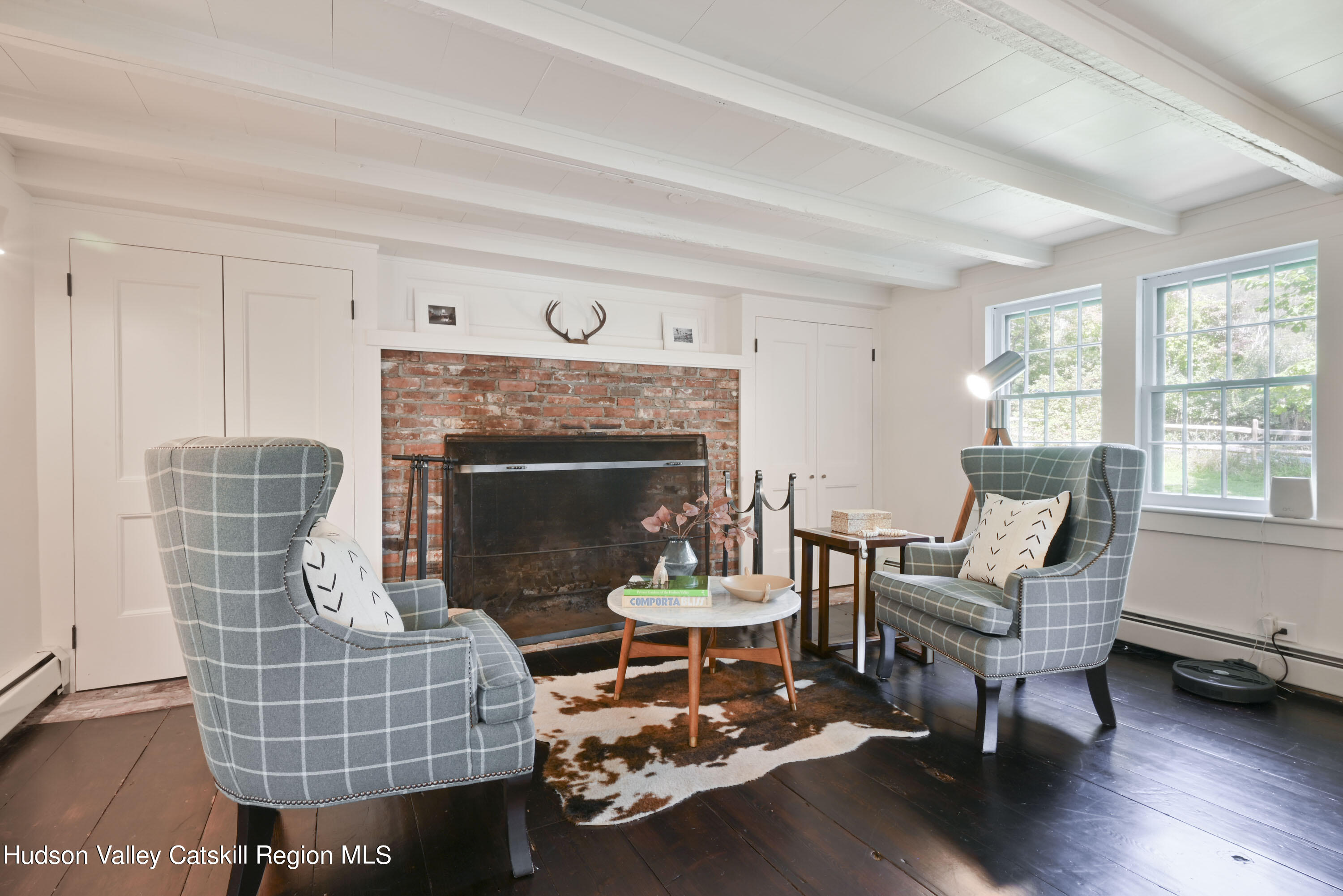 351 Peak Road Stone Ridge, NY 12484 - Photo 13 of 32 a living room with furniture wooden floor and a fireplace