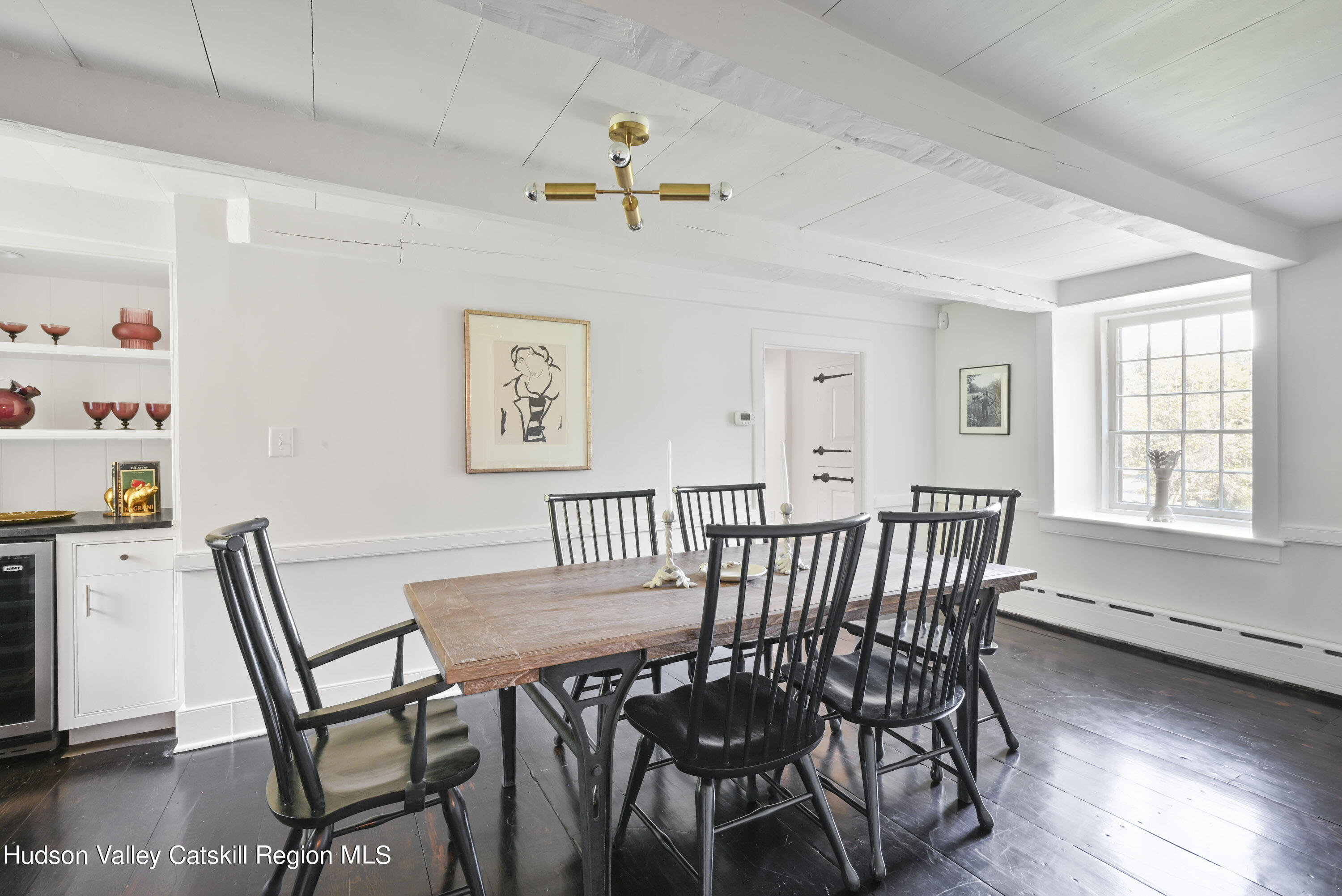 351 Peak Road Stone Ridge, NY 12484 - Photo 15 of 32 a view of a dining room with furniture window and wooden floor