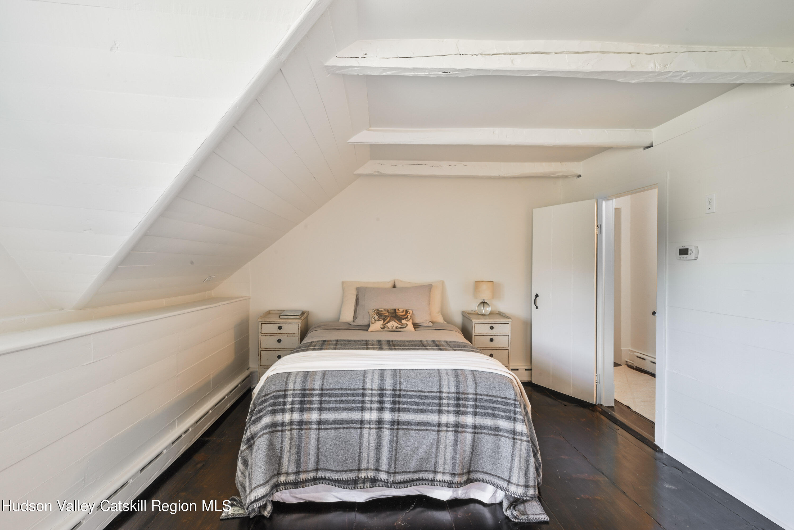 351 Peak Road Stone Ridge, NY 12484 - Photo 21 of 32 a bedroom with a bed and wooden floor