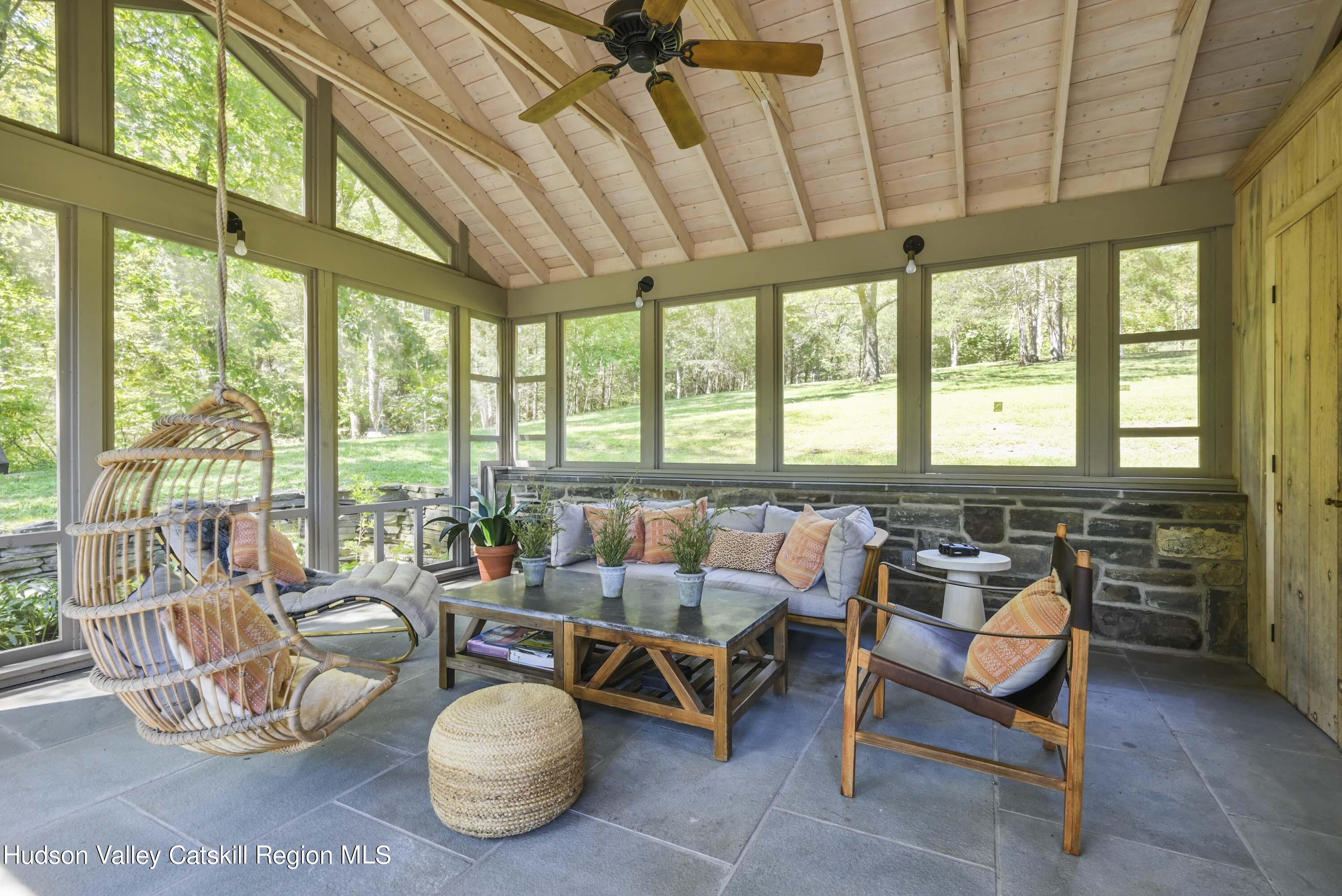 351 Peak Road Stone Ridge, NY 12484 - Photo 27 of 32 a living room with furniture a rug and a large window