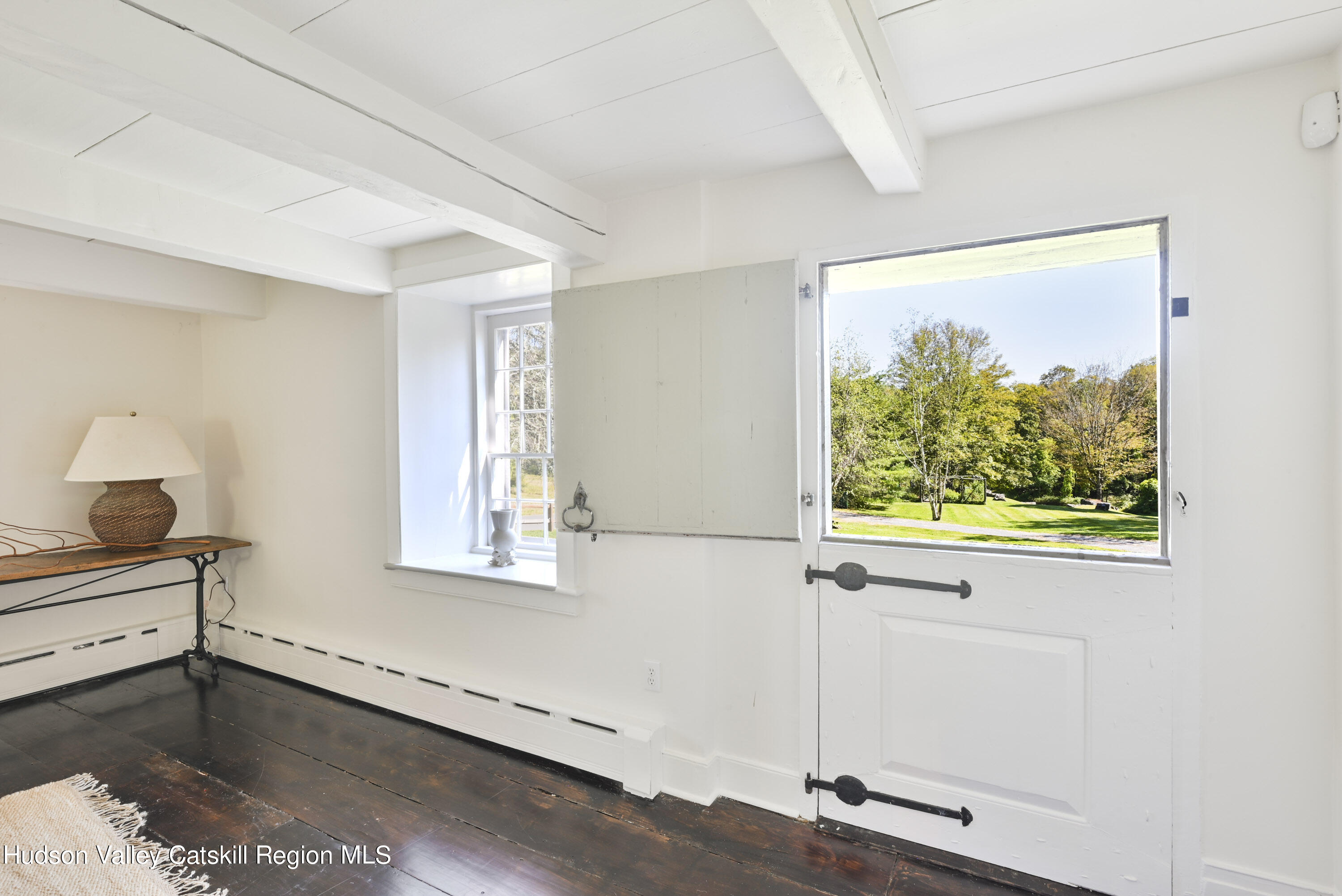 351 Peak Road Stone Ridge, NY 12484 - Photo 6 of 32 a view of an empty room with wooden floor and a window