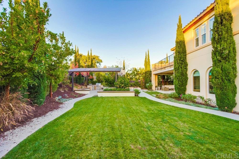 7177 Sitio Corazon Carlsbad, CA 92009 - Photo 11 of 41 a view of a patio with table and chairs and potted plants