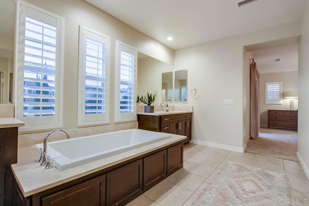 7177 Sitio Corazon Carlsbad, CA 92009 - Photo 28 of 41 a bathroom with a tub sink and mirror