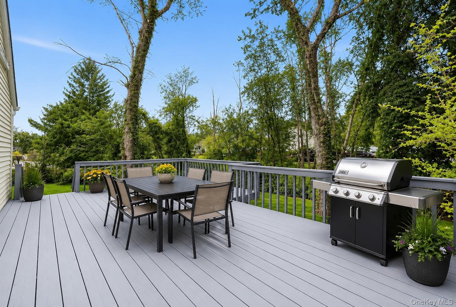 785 Locksley Road Yorktown Heights, NY 10598 - Photo 14 of 16 Spacious outdoor deck featuring light gray composite decking and matching railings photos have been digitally enhanced to illustrate the property's potential.