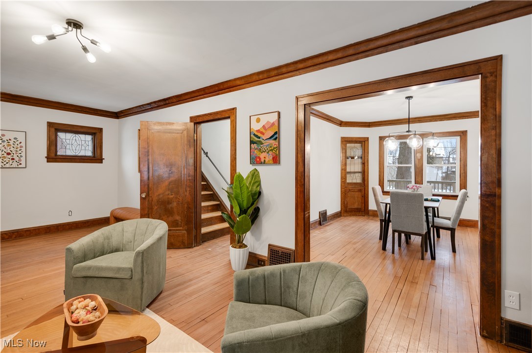 2016 Rossmoor Road Cleveland Heights, OH 44118 - Photo 13 of 46 Living area with ornamental molding, light wood-style flooring, and stairway